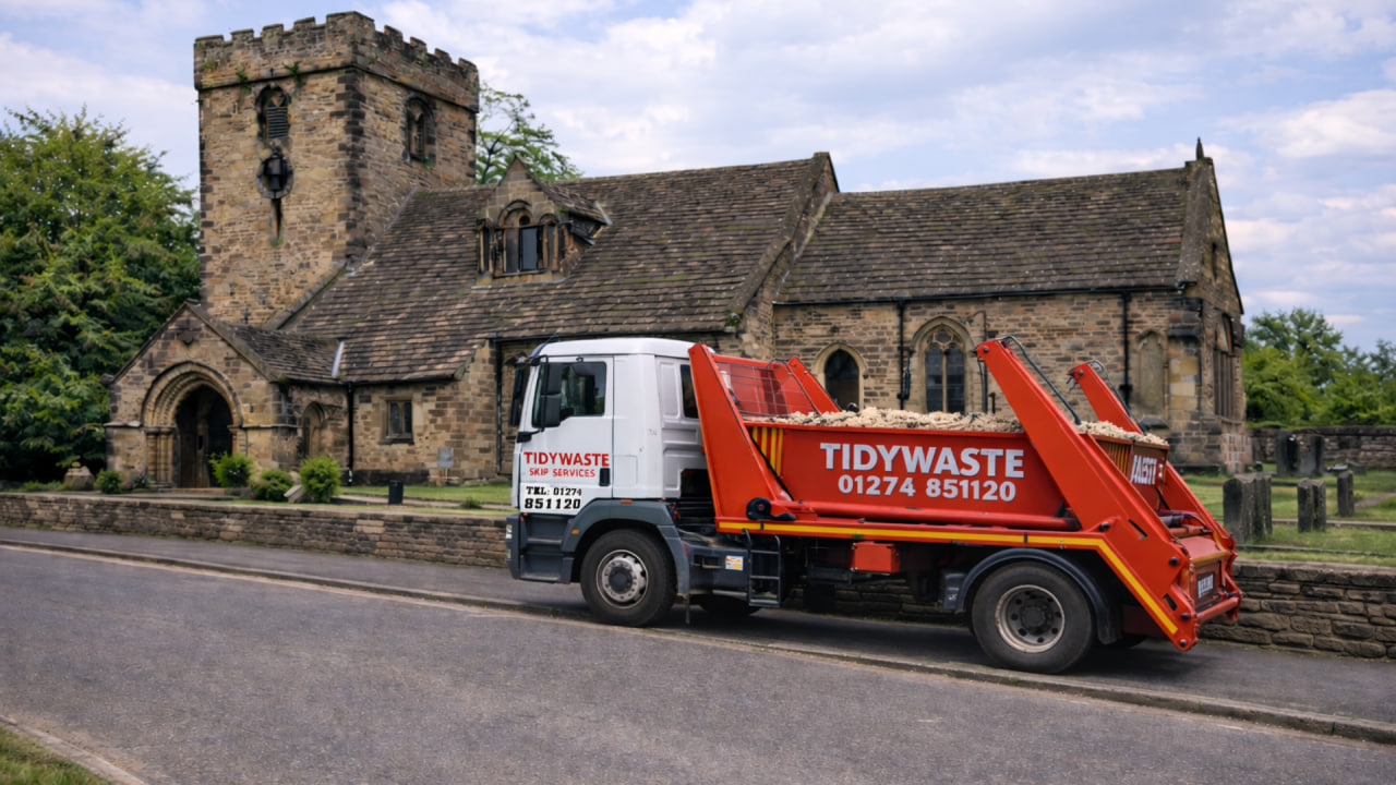 TidyWaste Skip Hire Vehicle next to St. Peter's Church in Liversedge